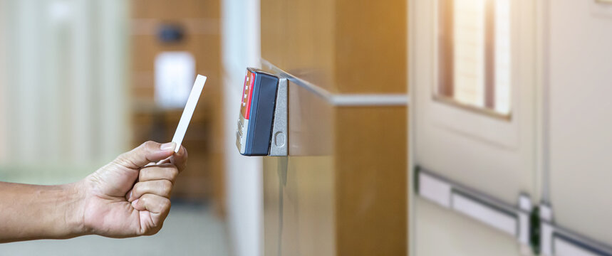 Proximity card reader door unlock, Hand security man using ID card on fingerprint scanning access control system for identity verification to open the door or for security safety or check attendance.