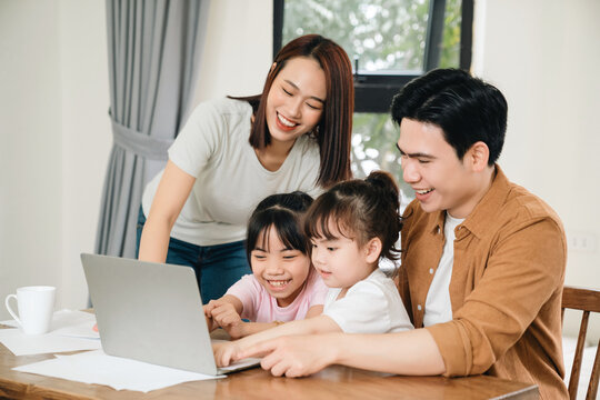 Young Asian Family At Home