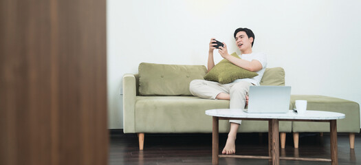 Image of young Asian man at home