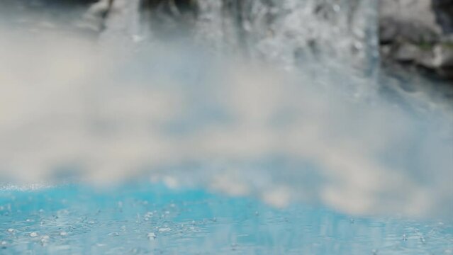 close up of the water of a river. water with foam. camera submerged by water. selective focus of a river. water from a waterfall flowing