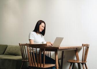 Image of young Asian woman at home