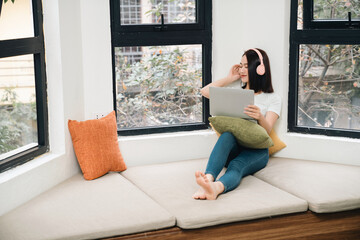 Image of young Asian woman at home