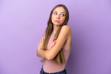 Young Lithuanian woman isolated on purple background making doubts gesture while lifting the shoulders