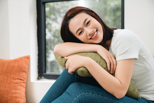 Image of young Asian woman at home