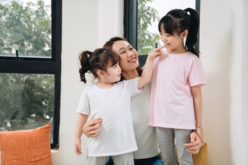 Obraz premium Image of young Asian mother and daughter at home