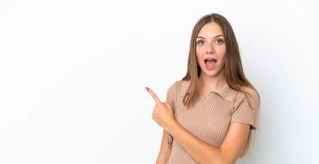 Young Lithuanian woman isolated on white background surprised and pointing side