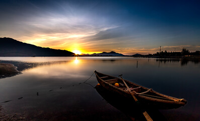 Beautiful sunset at the lagoon with the boat the main focus. The concept of lonely feeling