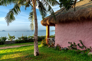 The colorful bungalows with decorative walls in form of Vietnamese rural style in Backpacker Hostel in Ninh Van commune, Khanh Hoa province, Vietnam