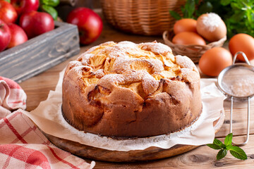 Homemade sponge cake on a rustic wooden cutting board on a table