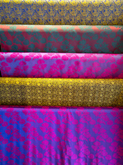 Colorful silk texture background. At a silk shop in Van Phuc village. Silk fabrics here are woven...