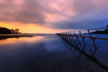 Wooden bridge on the beach at dawn in Phu Quoc island, Vietnam. Long exposure time