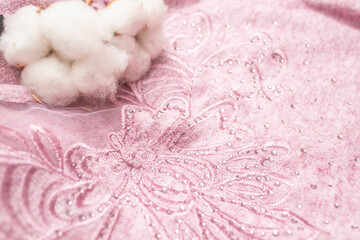 pink blouse textured model with cotton flowers, soft focus close up