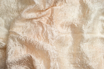 Beige golden fabric with visible sillky threads texture