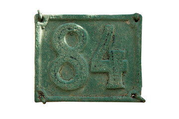 Old retro weathered cast iron plate with number 84 closeup isolated on white background