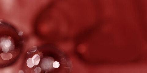 Wine glasses defocused banner, red wine color blurred background with light flare, optical blur,...