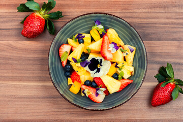 Fruit salad decorated with flowers.