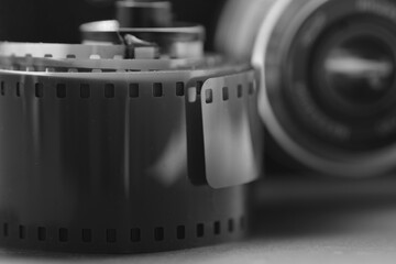 scratched dusty photo film stripe and retro camera lens in the background. 35mm negative film...