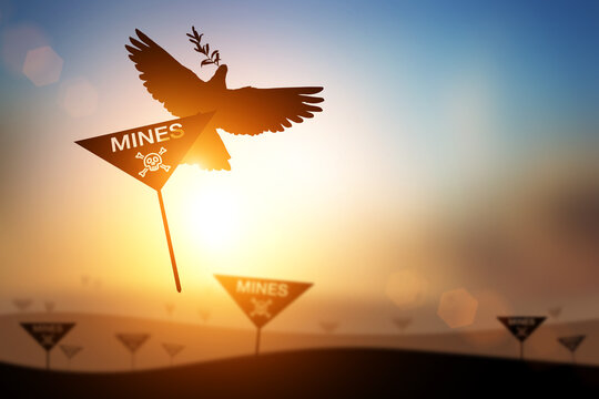 Silhouette of Dove carrying Mines Sign and skull and crossbones symbol for International Day for Mine Awareness and Assistance in Mine Action,4 April 