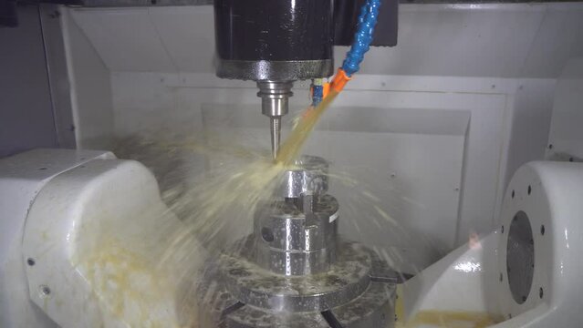 The 5-axis CNC milling machine cutting the automotive parts with ball end mill tool.