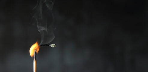 Burning down of matchstick on black background with copy space. Burnout Syndrome concept