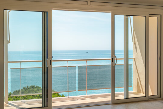 Fototapeta Gorgeous view from the hotel room through the panoramic window to the sea on a sunny warm summer day with blue skies in a luxury resort. Copyspace