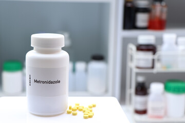 Metronidazole pill in white bottle, pill stock