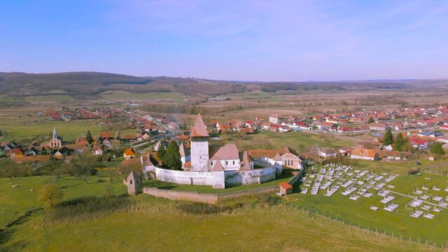 Aerial video of the fortified church at Hosman village, Romania. Video was shot from a drone while flying forward towards the fortification with camera level for a panoramic view.