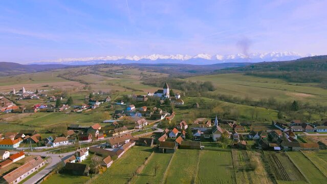 Aerial video of the fortified church located in Hosman village, Sibiu county, Romania. Footage was shot from a drone while flying backwards, away from the fortification.