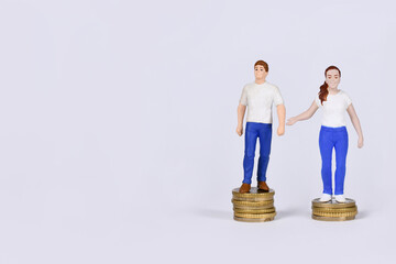 Gender pay gap concept with man and woman standing on different amount of coins with copy space