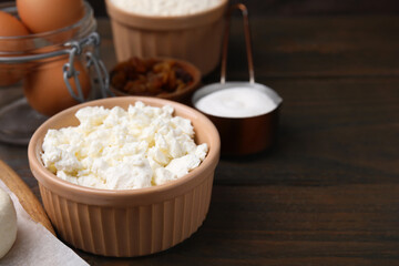 Different ingredients on wooden table, space for text. Cooking cottage cheese pancakes