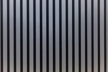 Slatted grey wooden wall panel. Modern ideas for decor and interior design, construction and renovation. Space for text. Front view.