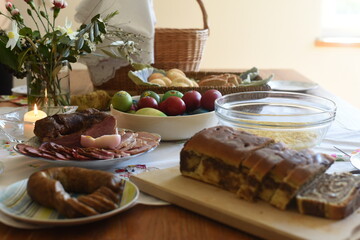 Close-up of Easter breakfast table with traditional slovenian dishes. Ham, colorful eggs, potica and horseraddish. - obrazy, fototapety, plakaty