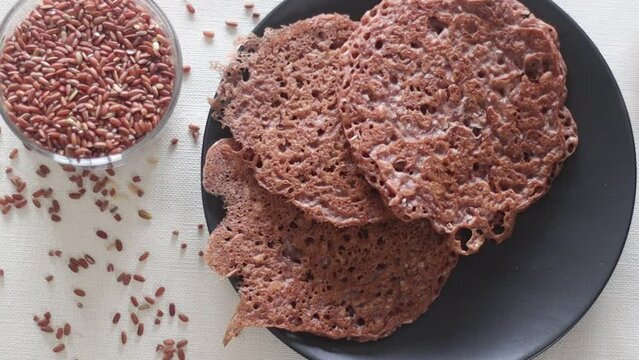 Serving red rice pancakes one over the other