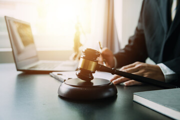 Judge gavel with Justice lawyers having team meeting at law firm background. Concepts of Law and...