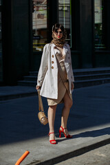 A girl in glasses walks around the city