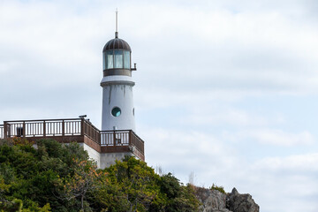 Fototapeta na wymiar Dongbaekseom Lighthouse at the Dongbaek Park of Busan