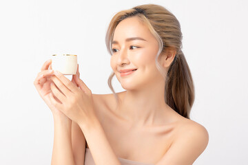 Happy beautiful young asian woman holding cosmetic cream blank bottle, Fashion model, Health wellness, Beautiful girl skin care and facial treatment. Isolated on white background.