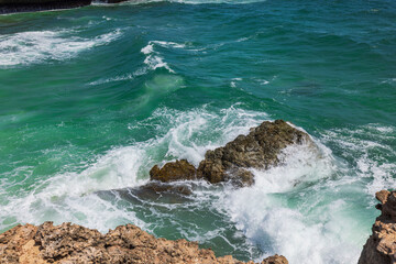 Beautiful view of rocky coast washed by Atlantic Ocean waves. Aruba. 