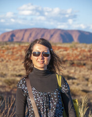 Portrait of a happy caucasian woman relaxing during a hike in the australian outback