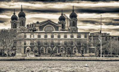 Ellis Island building exterior, view from moving boat in New Yor