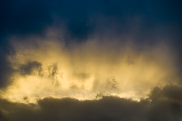 Sunlight breaking through dark sky clouds