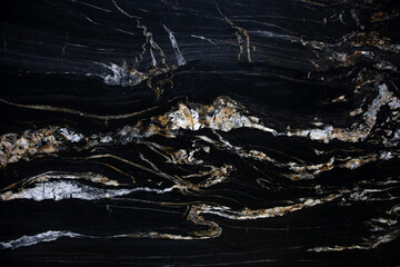 Black spanish matt granite slab with gold blured waved lagoon Belvedere - obrazy, fototapety, plakaty
