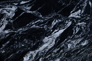 Black spanish matt granite slab with white blured waves Kalahari Black Extra close up