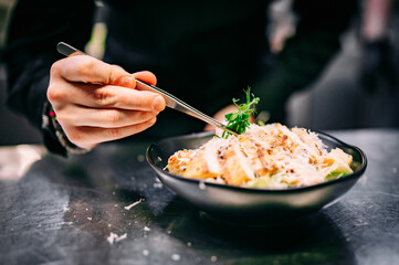 Chef cooking Caesar salad on restaurant kitchen