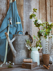 Garden tools and spring flowers garden terrace on a wooden background.