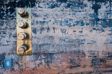 Brass standpipe ends set in rustic wall. - obrazy, fototapety, plakaty