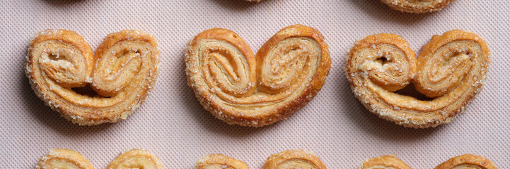 Palmier cookies or puff pastry ears on tray