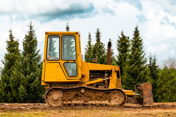 Small crawler bulldozer left on the construction site