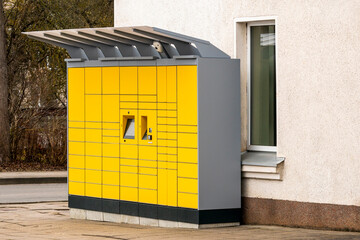 Yellow parcel pick up station on the street