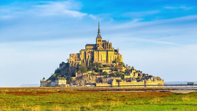 Famous Mont-Saint-Michel at sunset, time lapse. Beautiful French landmark Mont Saint-Michel at sunset time, Normandy, France. Timelapse video